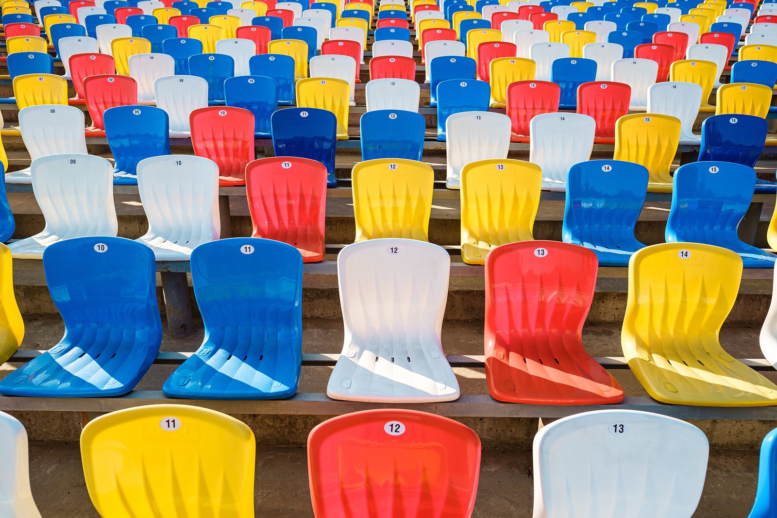 colorful-empty-seats-in-rows-on-sports-stadium-2023-11-27-05-18-36-utc